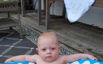 Hilarious Photo Of A Baby Looking Like A Mob Boss In The Pool